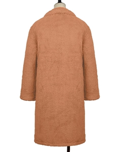 Back view of a long teddy bear coat in caramel faux lamb wool with a plush texture