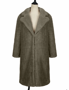 Detailed view of the thick taupe faux lamb wool texture on the oversized winter coat
