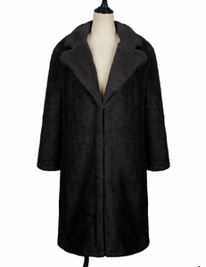 Detail shot of black oversized faux fur teddy coat featuring a wide lapel and curly texture