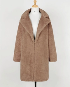 Detailed texture of the wide collar and soft faux fur on a tan teddy winter coat