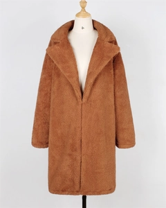 Detail view of the thick caramel faux fur texture and large lapel of this winter coat