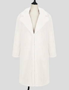 Close-up of white faux fur coat with oversized lapel and soft teddy texture detail