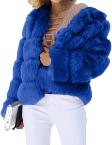 Detailed view of plush royal blue faux fur coat texture with silver handbag accent