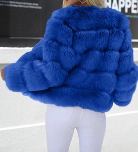 Rear view of cobalt blue faux fur short jacket featuring a thick horizontal paneled design