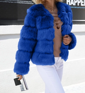 Detail of layered faux fur texture on bright blue jacket for fashion street style