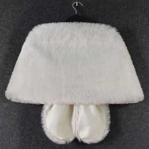 Close-up of white faux fur shawl and matching satin-lined gloves set for winter