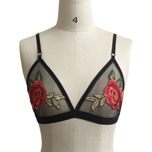Floral embroidered black mesh bralette with red rose patterns on a white mannequin