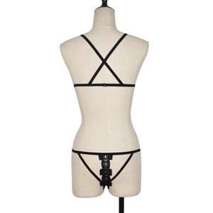 Lace cutout lingerie set in black with strappy back design shown on a beige mannequin