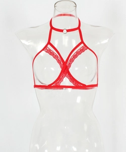 Detailed view of red sexy lingerie with lace trim, metal ring and cross straps on mannequin