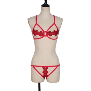 Red lace hollow lingerie set with geometric harness bra and matching embroidered thong
