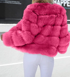 Macro detail of the bright rose pink faux fur jacket showing the textured square grid pattern