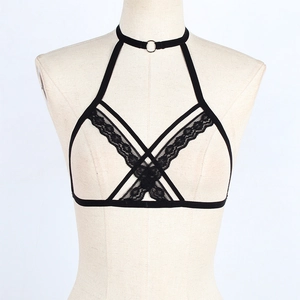 Detail of black harness bra with lace trim, elastic straps and metal ring connector