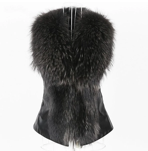 Detail of black faux fur vest showing plush texture and sleek faux leather patchwork panels