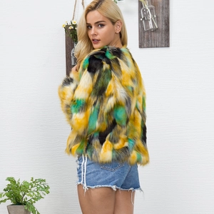 Detail view of colorful faux fur jacket with vibrant yellow and green block patterns