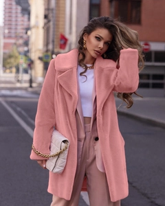 Detailed texture of women's soft pink faux fur coat with elegant large lapel design