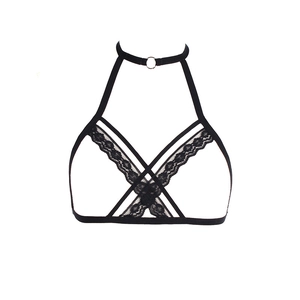 Detailed macro shot of black lace trimming and metal rings on a sexy harness bra