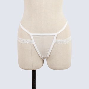 Detailed view of white lace thong featuring mesh fabric and intricate floral side wings