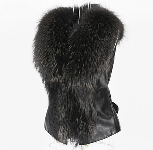 Close-up of black faux leather vest featuring a luxurious thick faux raccoon fur collar