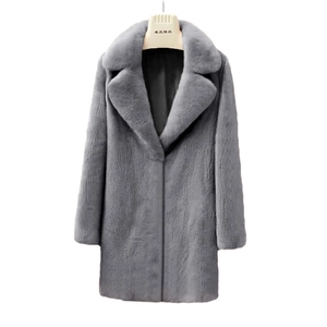 Detail of grey faux fur coat featuring a wide lapel collar and soft plush texture