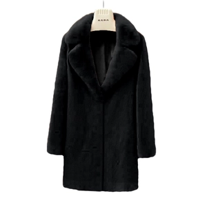 Detail view of a black faux fur coat with a wide lapel collar and soft plush texture