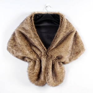 Detail view of brown faux fur shawl with dense plush texture and silky black lining