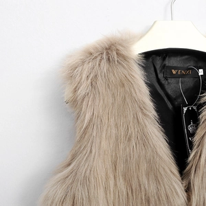 Detail of faux fox fur vest showing khaki texture with smooth black satin lining and tags