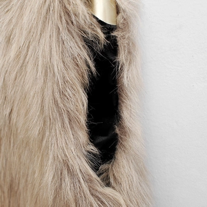 Detail view of faux fox fur texture in camel brown with soft long plush and black lining