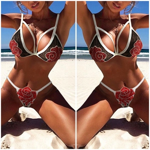 Sexy black lace floral bikini set with red rose embroidery on a sunny beach