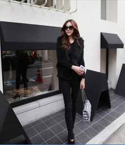 Chic urban outfit featuring a black faux fox fur vest paired with a houndstooth chain bag