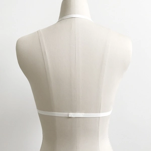 Detail of white minimalist strappy halter bra showing thin elastic back band and buckle