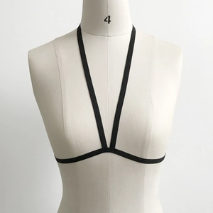 Detailed view of black elastic strappy body harness with halter neck and V-shaped design