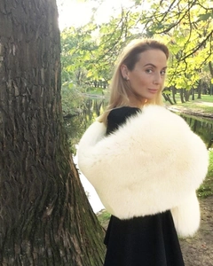 Luxurious white faux fur shawl with thick plush texture worn over a black formal dress