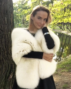 Close-up of white faux fur shawl with dense soft fibers and long fluffy texture