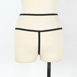 Minimalist black lace thong with elastic strappy design on a mannequin display