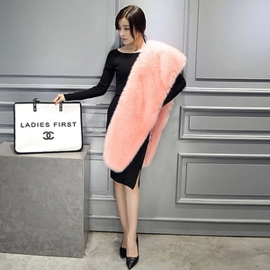 Detailed view of thick pink faux fur shawl worn with a black dress for winter fashion