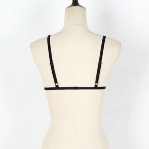 Detail of minimalist black lace strappy bra with elastic back bands on mannequin