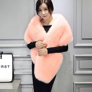 Close-up of a soft pink faux fox fur shawl wrap styled with a black dress