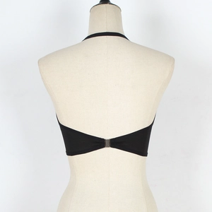 Detail of black strapless crop top featuring a V-cut back with silver metal buckle closure