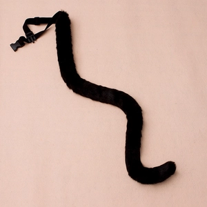 Close-up of black faux fur tail with adjustable nylon belt and plastic buckle for cosplay