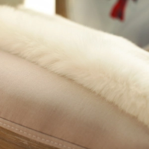 Detail shot of the white faux fur texture showing soft and glossy high-quality fibers