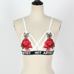 Detail of white lace bralette with red rose embroidery and HOT ARTIST elastic band