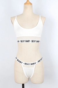 Detailed view of white two-piece lingerie set with SEXY BABY lettered elastic bands