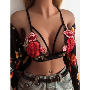 Lace bra top with vibrant red rose embroidery and thin straps in a deep V-neck style