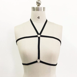 Detail of black elastic body harness with silver rings on a mannequin torso