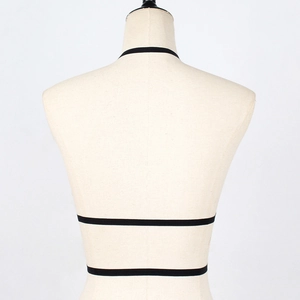 Detail view of the elastic black body harness straps on a mannequin back profile