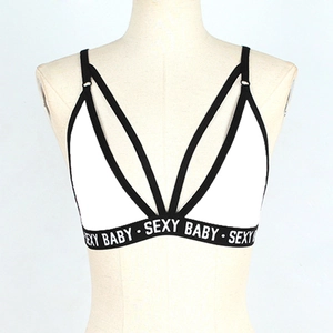 Detail of white bra top with black straps and SEXY BABY lettered elastic band