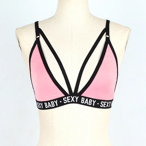 Detail of pink and black crop top with SEXY BABY lettering and cross back straps
