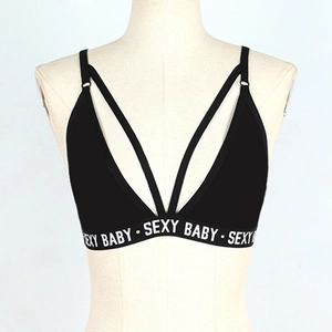 Detail of black V-neck bra top with crisscross straps and SEXY BABY elastic band