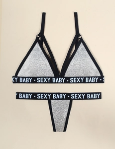 Detailed view of grey lingerie set with white SEXY BABY lettering on elastic bands