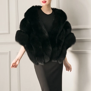 Detailed texture of thick black faux fox fur shawl styled with an elegant evening gown